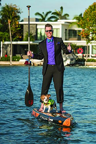 Nick Quay on his paddleboard with his dog