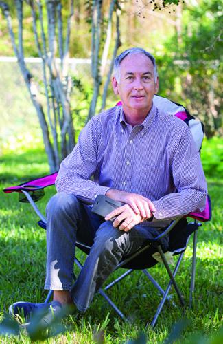 Photo of Jim Pruett sitting in camp chair