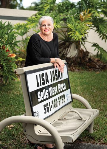 Photo of Lisa Jasky standing behind the bus bench with her name on it