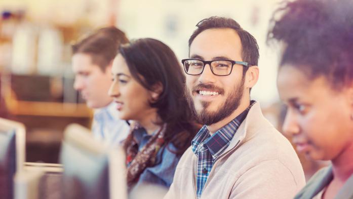 man sitting in class at computer