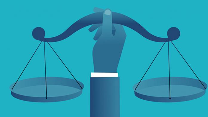Illustration of the scales of justice being held my a person's hand