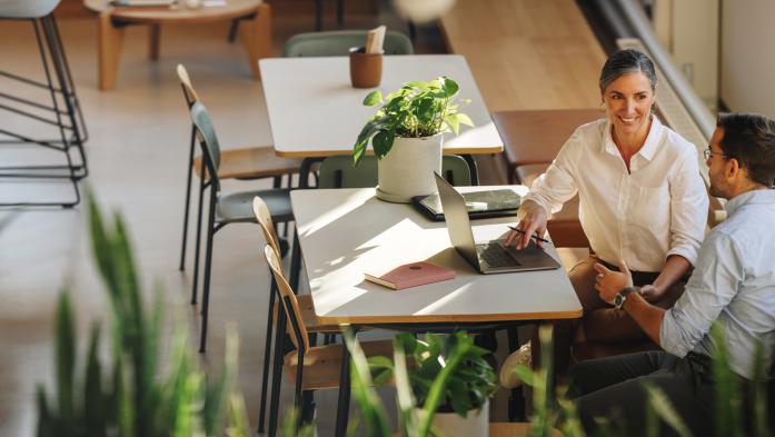 woman and man having project discussion in coworking office space