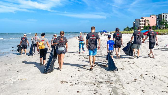 People on beach cleaning up litter