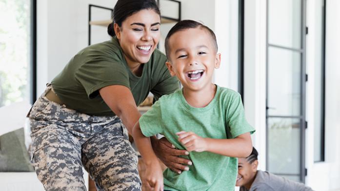 Photo of a military mom playing with her child, laughing