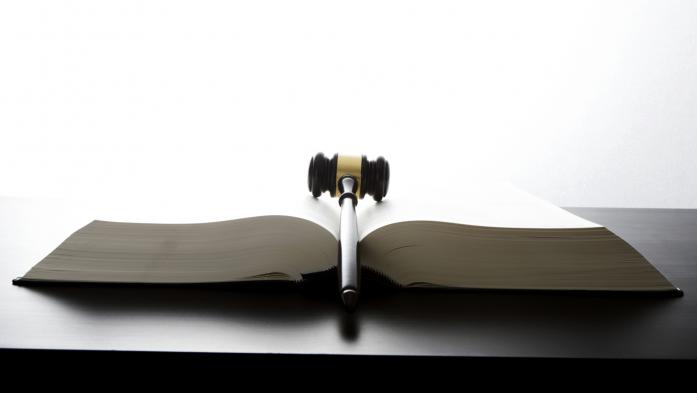 Legal gavel between the pages of an open book