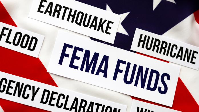 the words FEMA funds in a box appear on an American flag