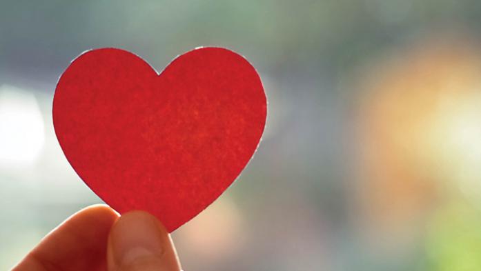 Hand holding a red heart shape