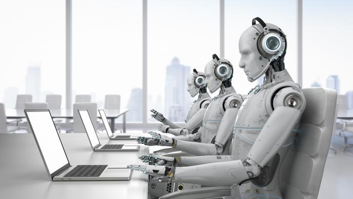 Line of robots sits in front of laptops with phones to their ears