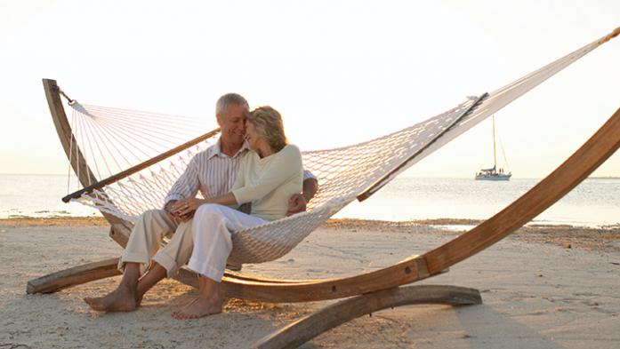 Photo of a senior couple on a hammock on the beach