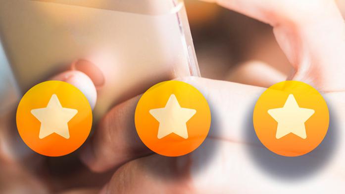 Photo of a person clicking 5 stars on her phone
