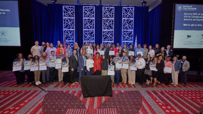 Large group photo of the fair housing groups representatives that will receive the latest HUD awards