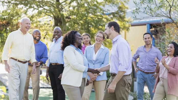Group of people with man and woman shaking hands