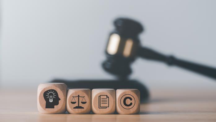 gavel with blocks representing ideas, scales, paperwork