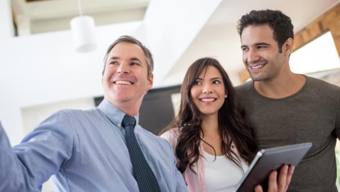 Realtor showing a couple a home