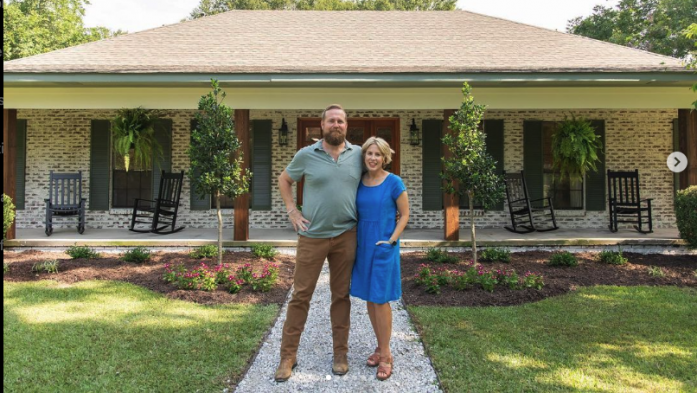 ben and erin napier standing in front of a house