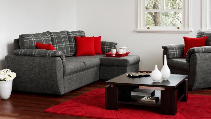 a touch of red in a living room. red pillows on a gray couch and chair and a red carpet