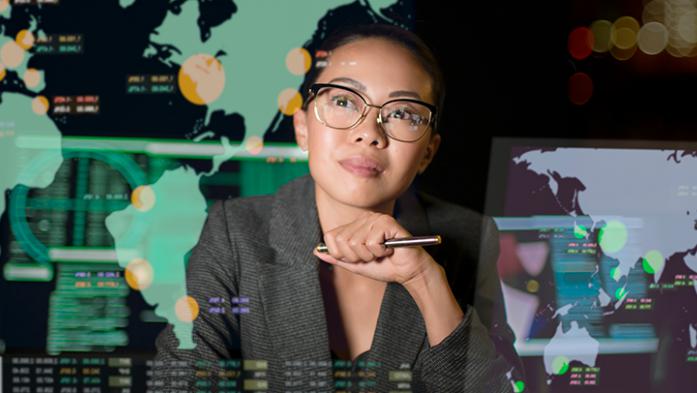 Photo illustration of an asian woman looking up at continents projected on wall