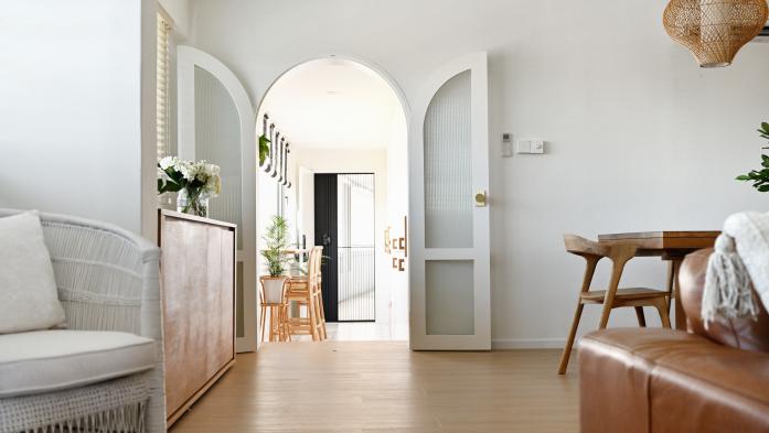 Arched doorway into a modern luxury home 