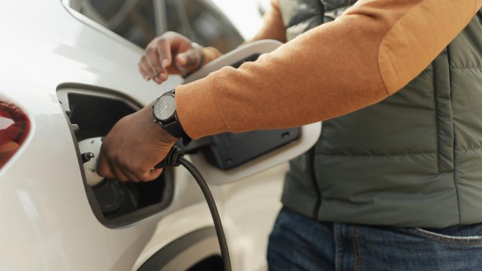 Close-up of  man charging electric car
