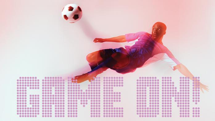 photo of soccer play kicking the ball with Game On! text overlapping