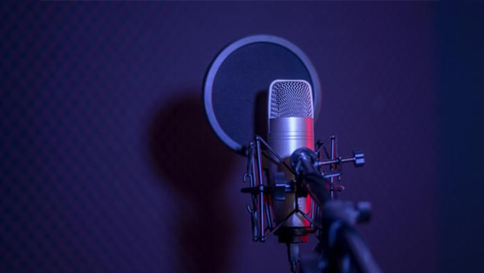 photo of microphone on purple background