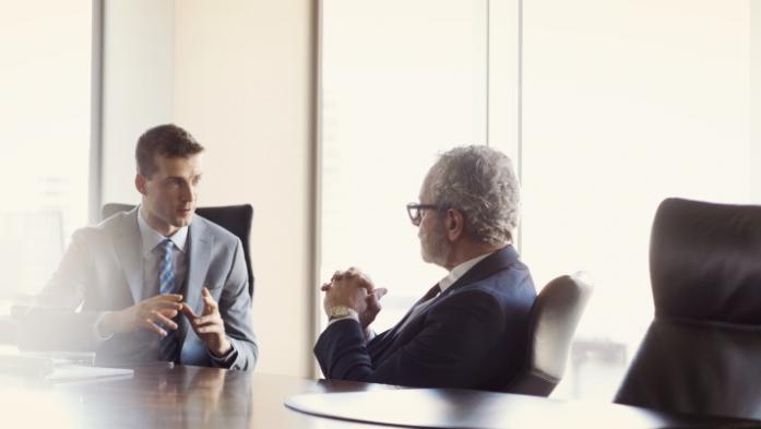 Businessmen talking at table