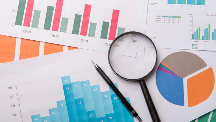 graphs and data with magnifying glass