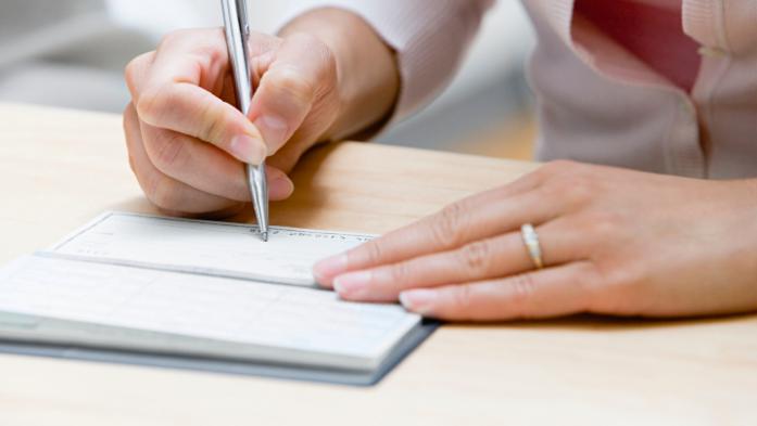 florida realtors pac logo with image of woman writing check