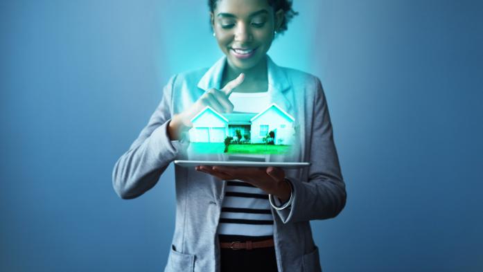 woman holding model of a house
