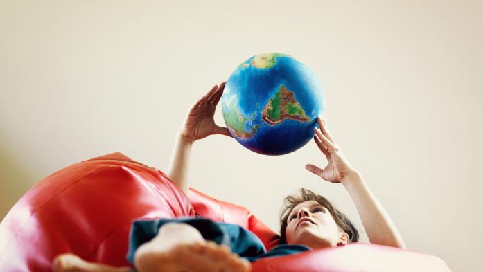 woman holding a globe