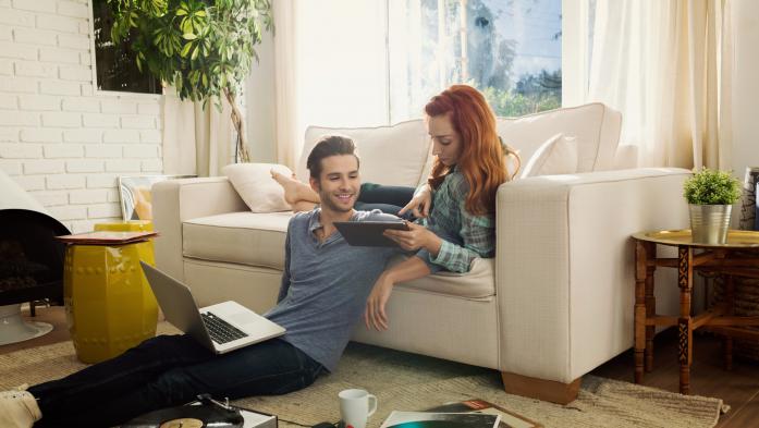 couple in living room looking at computer