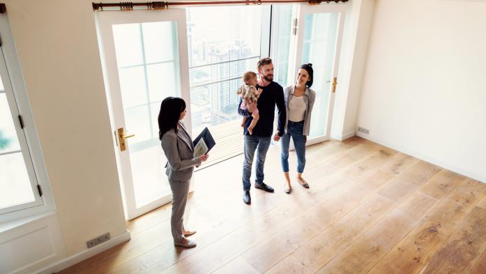realtor shows a family a house