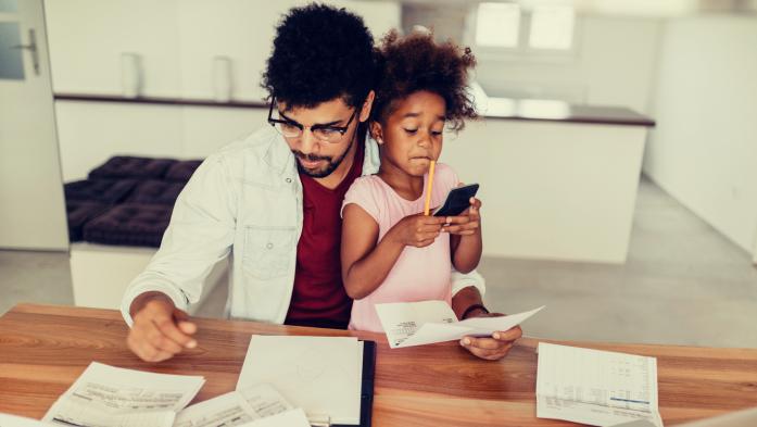 father daughter looking at financial paperwork