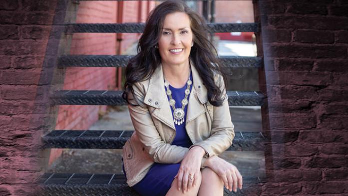 Linda Yates sitting on staircase outdoors