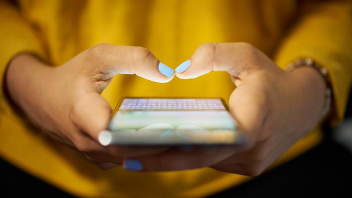 woman holding cell phone
