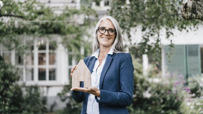 Realtor holding a model home