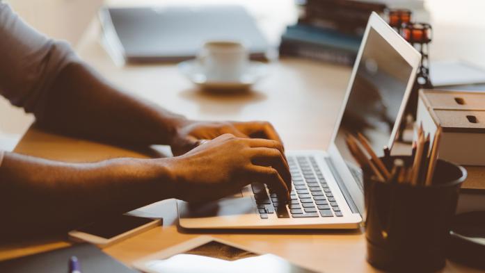 man typing on a computer