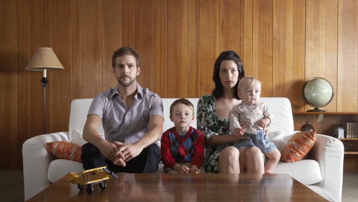 Parents and kids sitting on couch