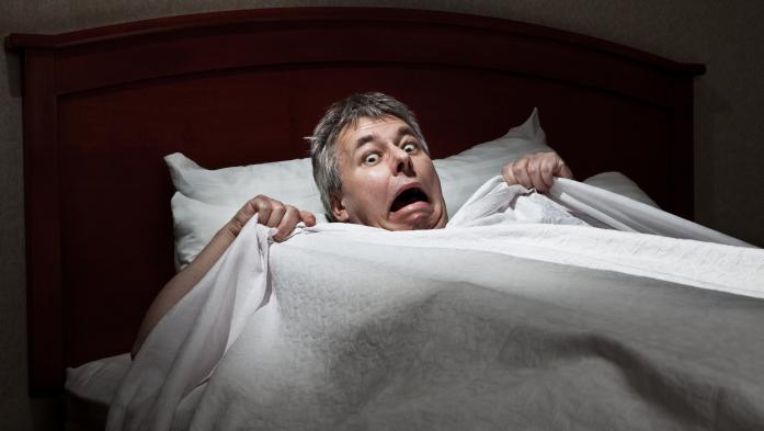 Scared man in bed