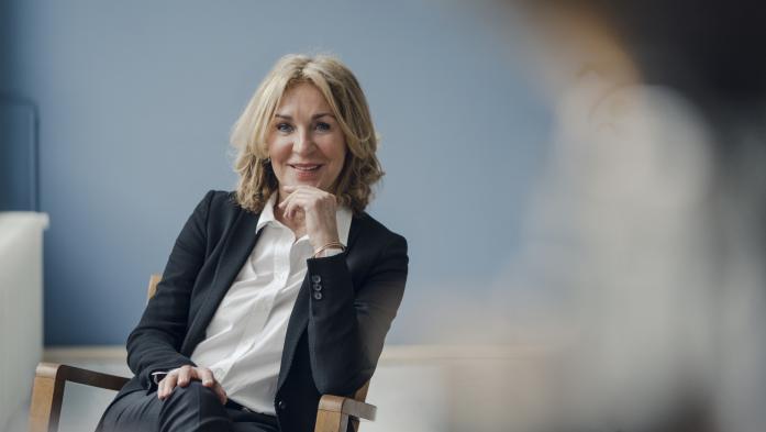 Businesswoman sitting in chair and smiling