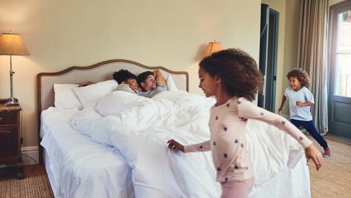 kids running around parents in bed