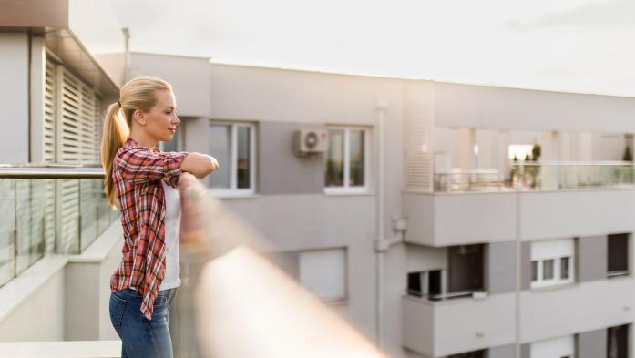 woman on apartment building balcony