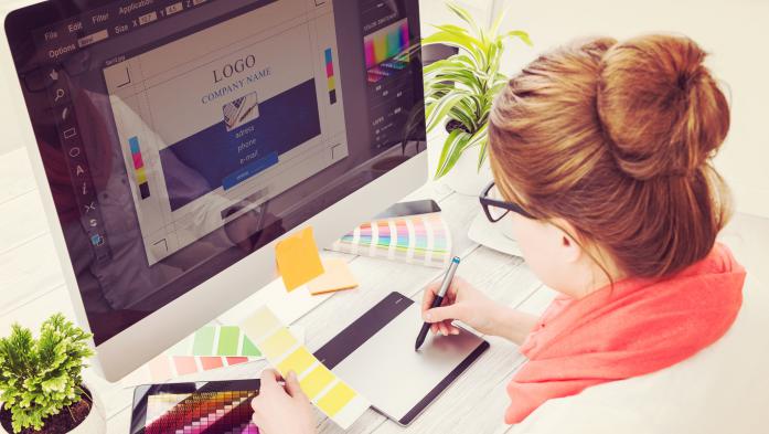 Woman looking at color palette and computer