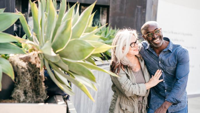 Happy couple walking on sidewalk