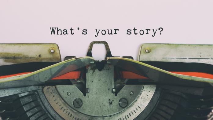 typewriter with words "what's your story?"