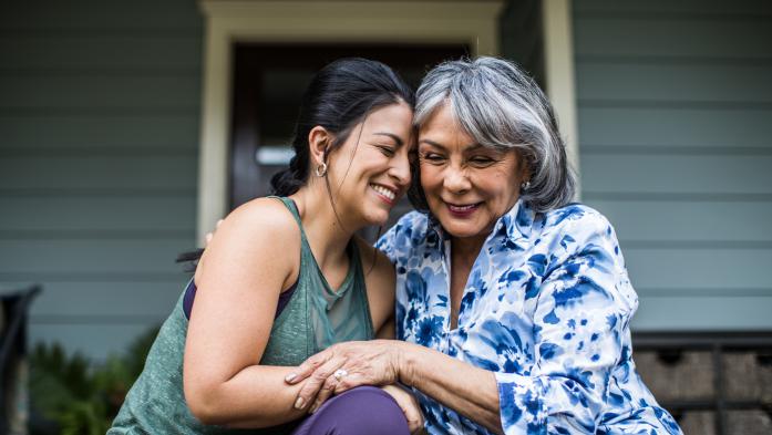 young woman and older woman hugging