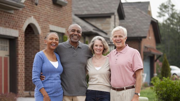 A black and white couple smile for a group photo