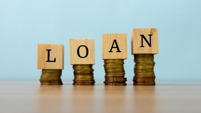 Blocks spell out loan and sit on top of change