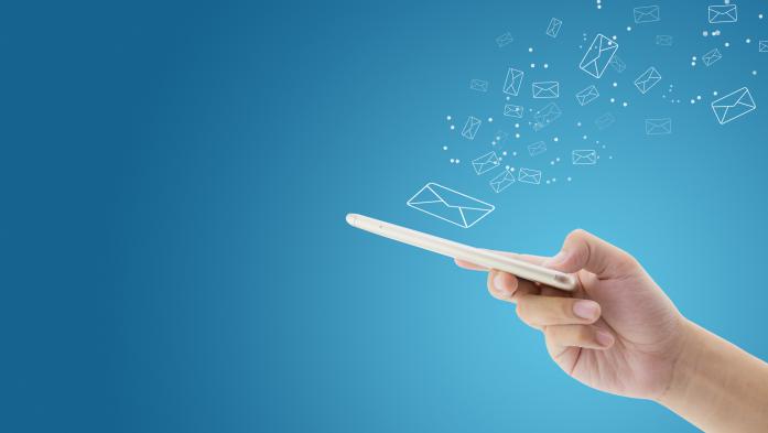 hand holding phone with drawings of envelopes floating 