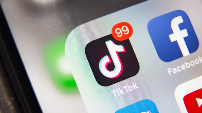Smart phone screen with icons for TikTok, Facebook and Twitter